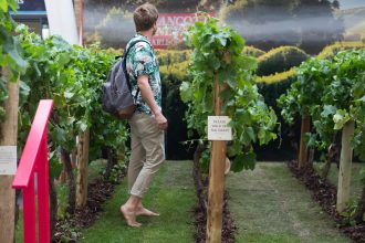 A commuter walks through the Brancott Estate pop-up vineyard at King's Cross Station, London