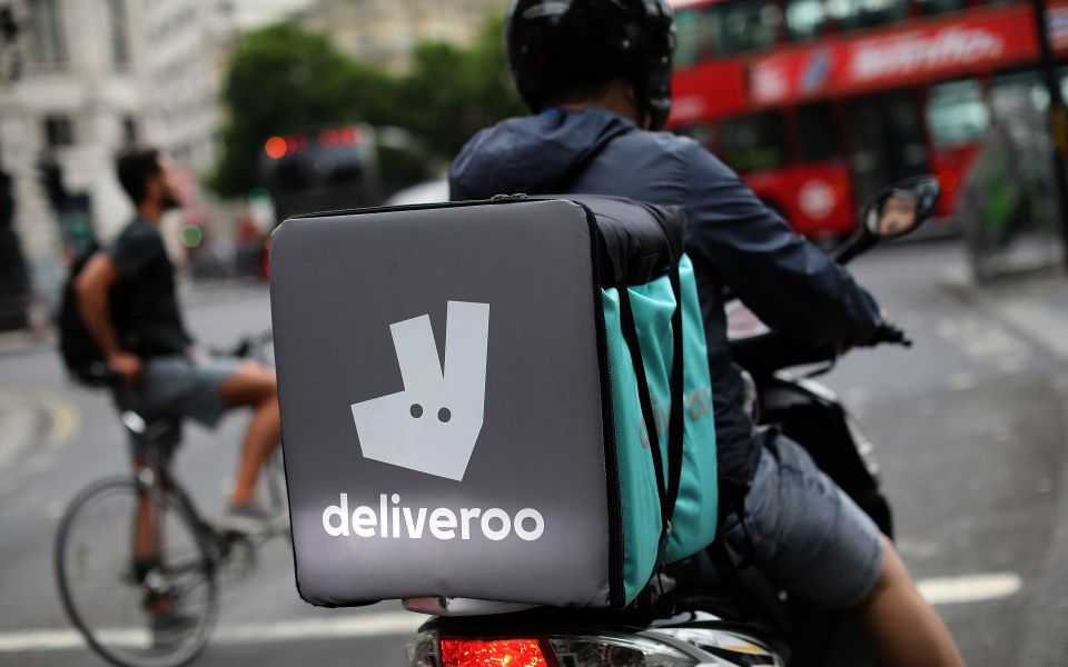 A deliveroo rider prepares to enter traffic