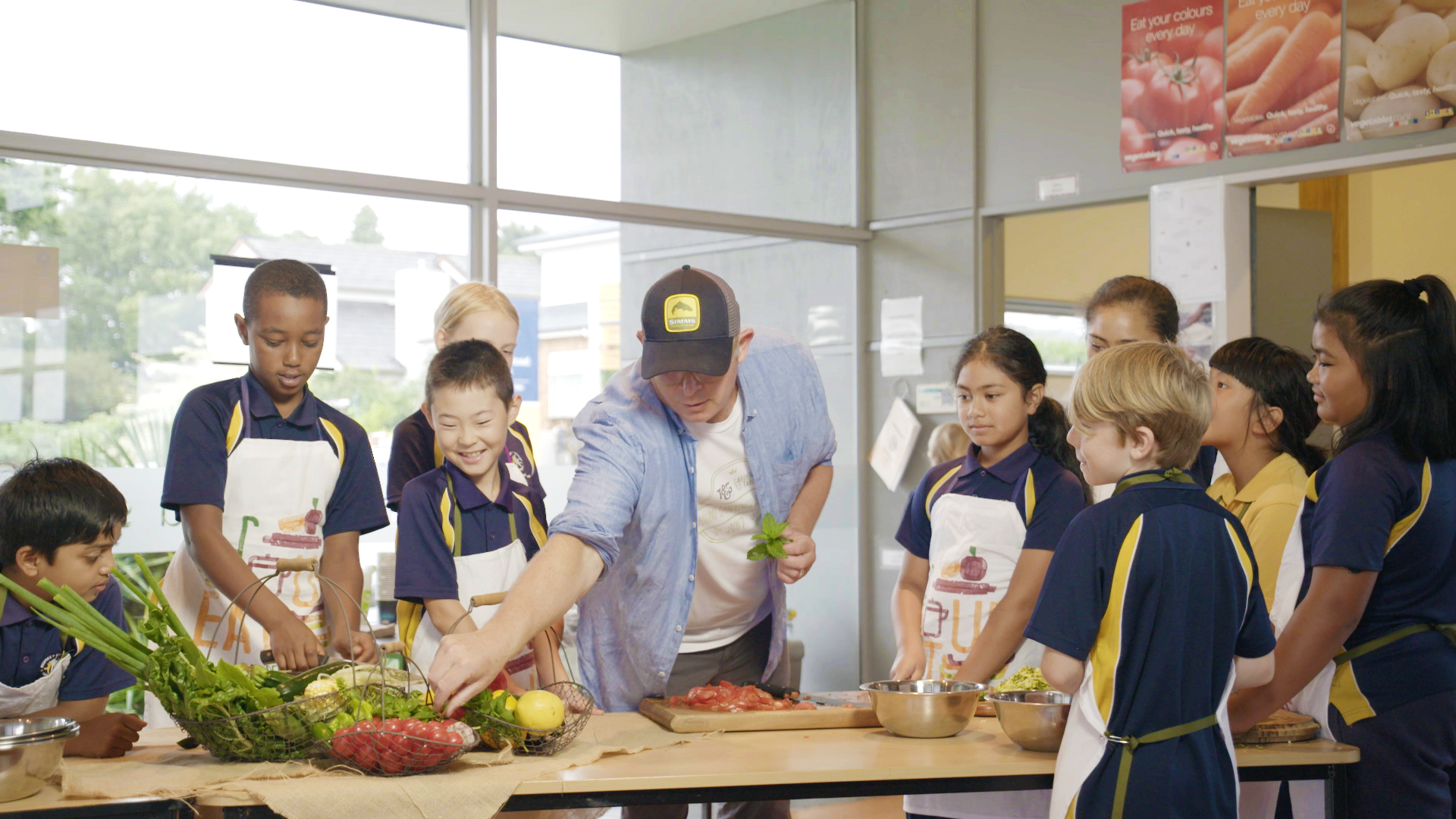 A group of school children watch Al Brown prepare a meal