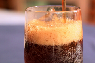 Soft drink is poured into a glass