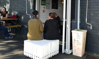 A compostable cup bin sits outside an Auckland cafe