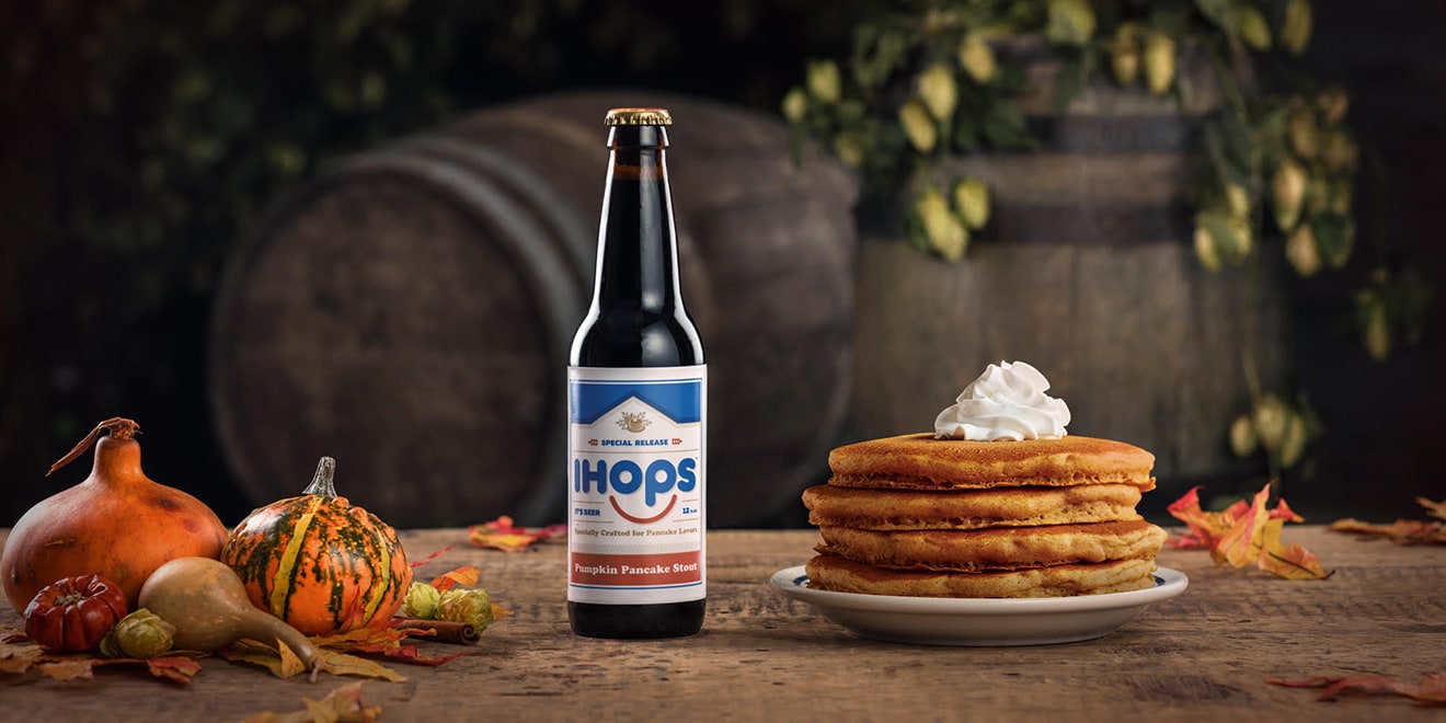 IHOP Pumpkin spice stout next to a plate of pumpkin spice pancakes