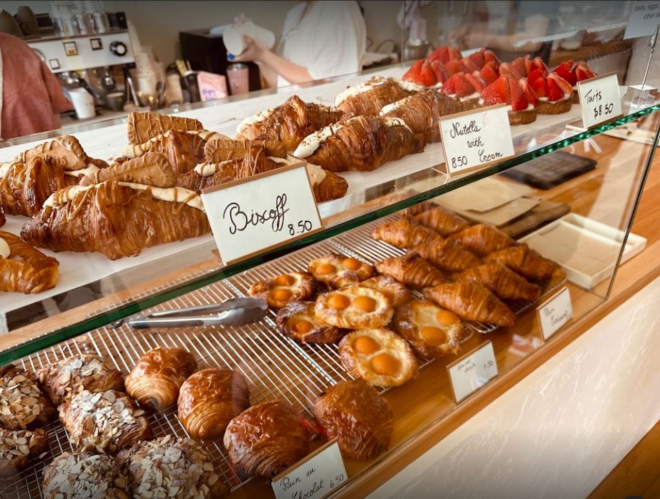 glass cabinet of bakery with an arrangement of pastries