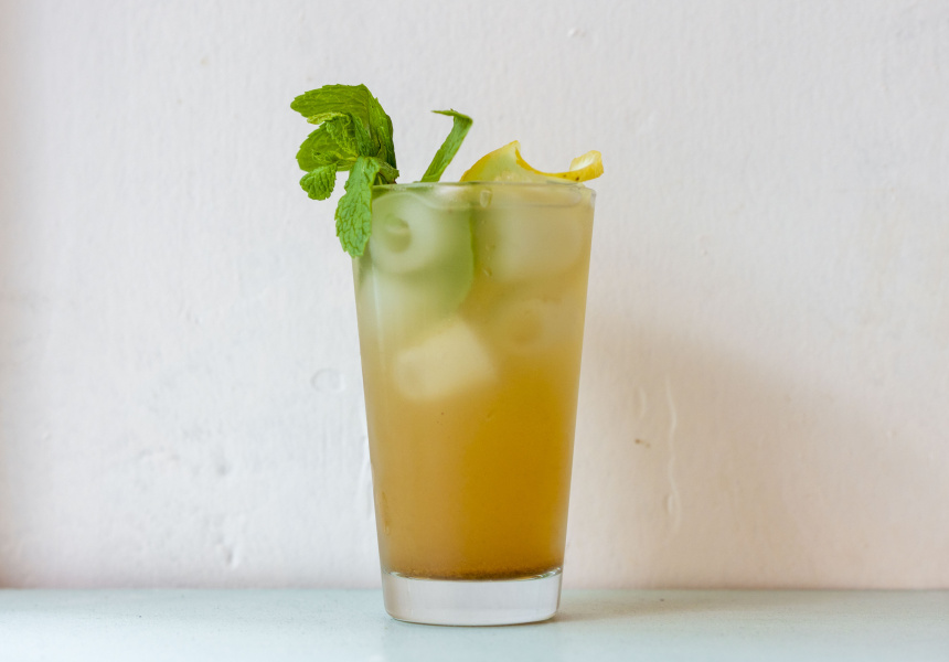 glass of cocktail with ice and celery