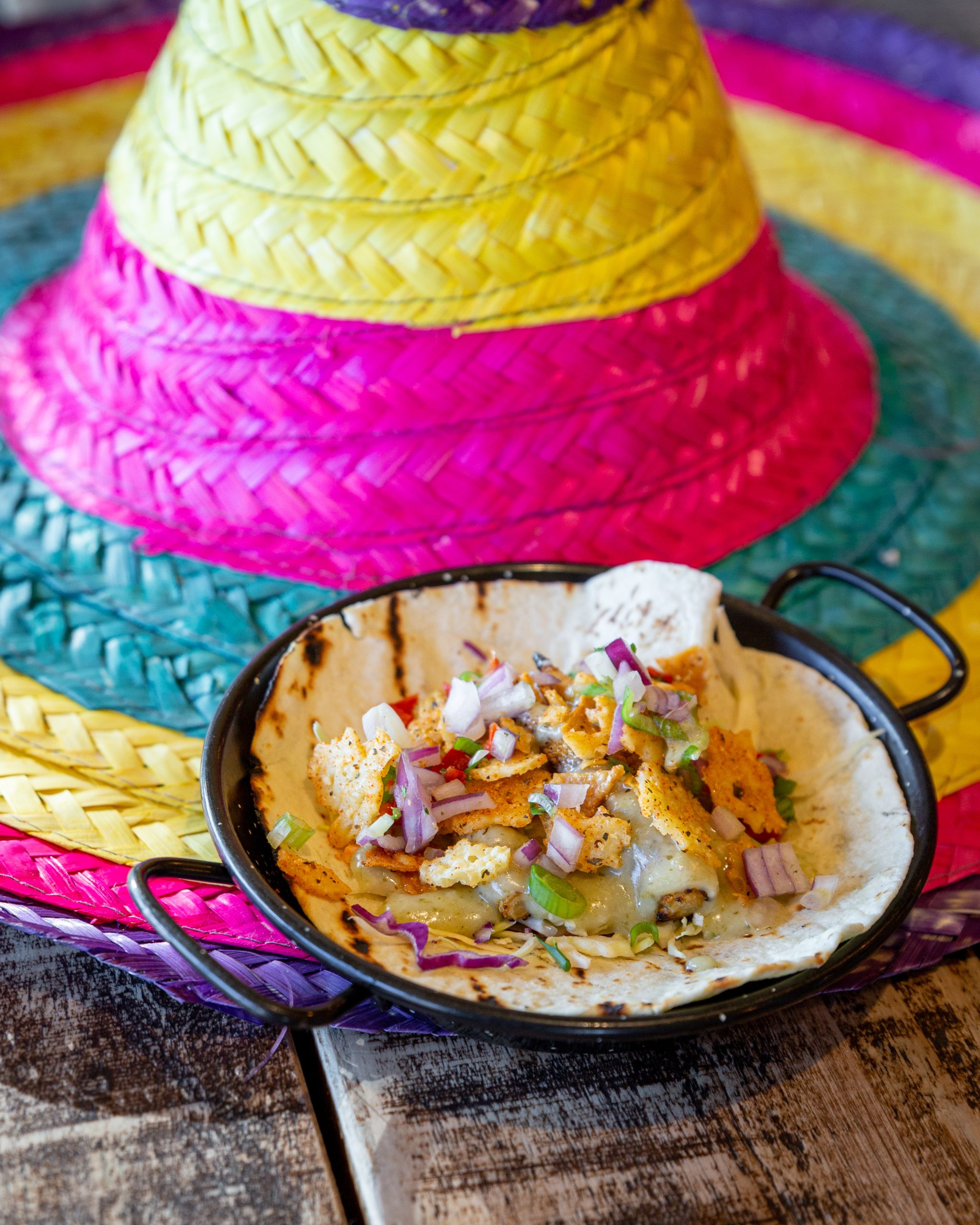 Sombrero with a plate of taco next to it