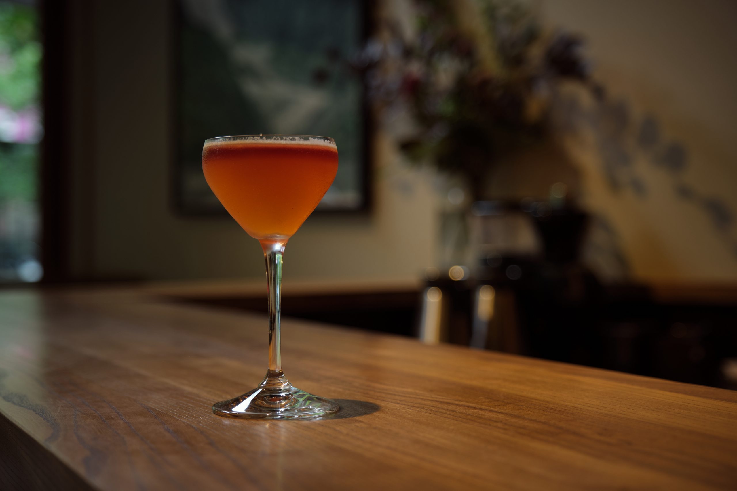 glass of natural orange wine on bar table