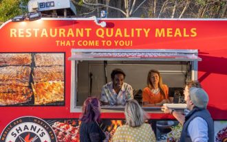 people serving inside food truck