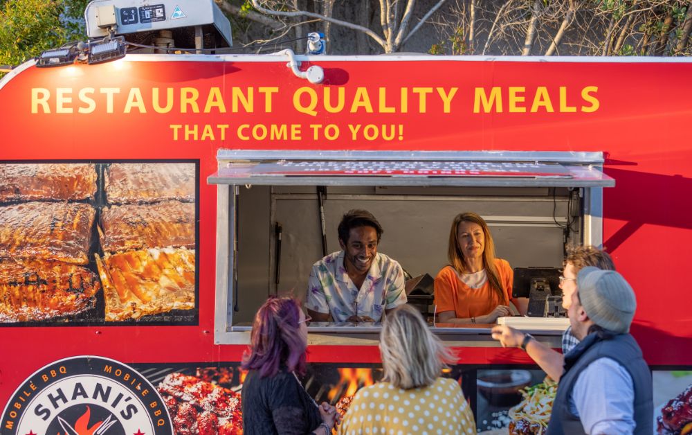 people serving inside food truck