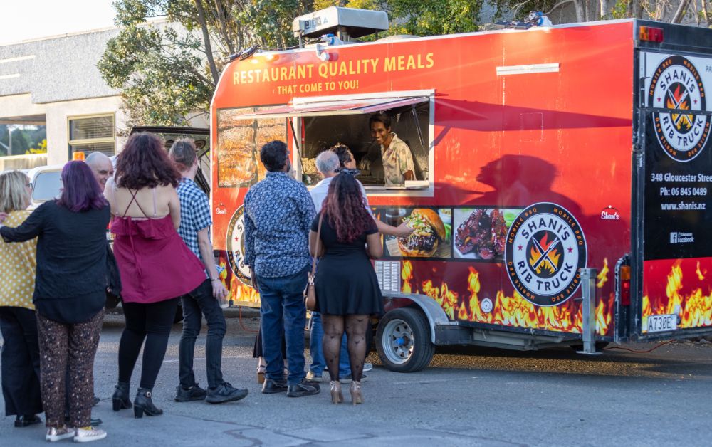 people lining up at food truck