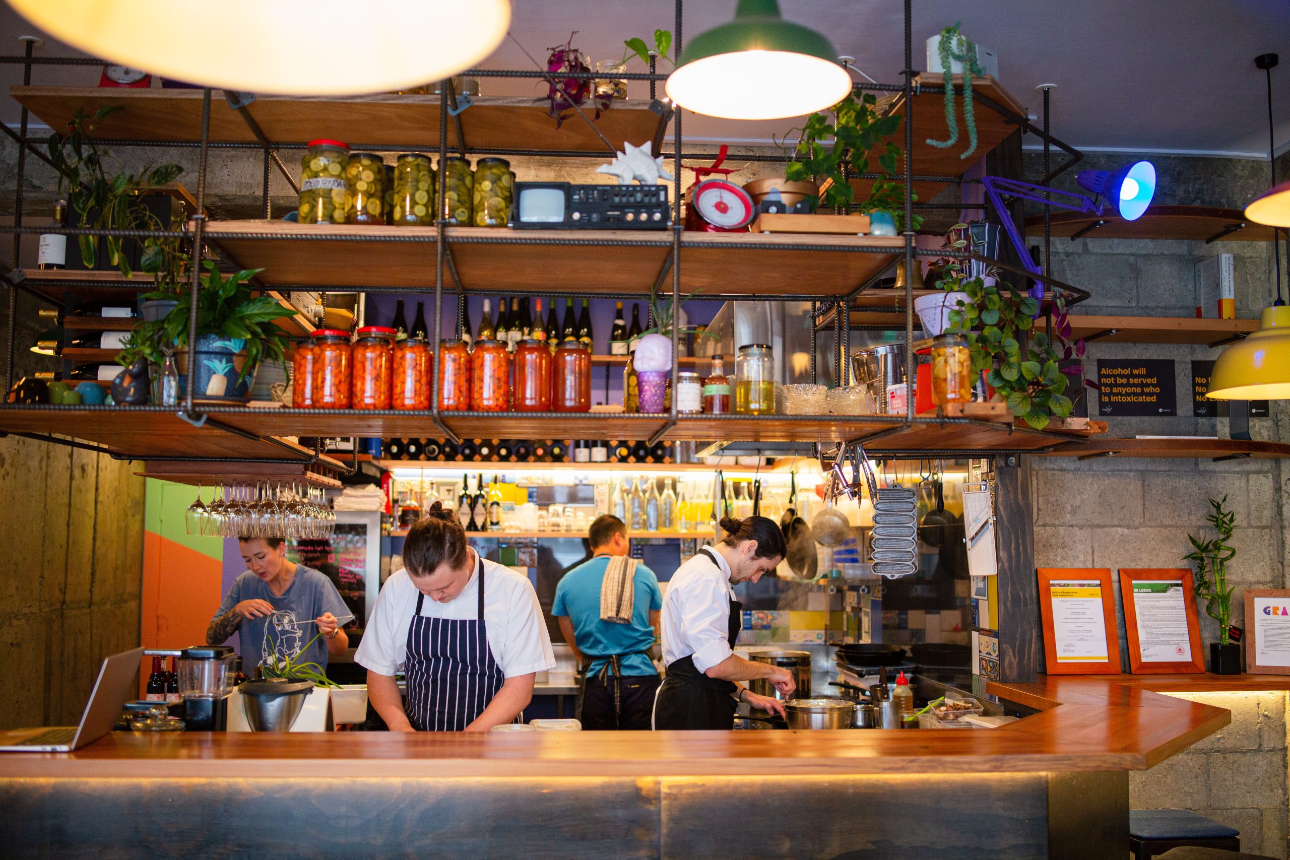 view of bar with chef and bartender standing behind