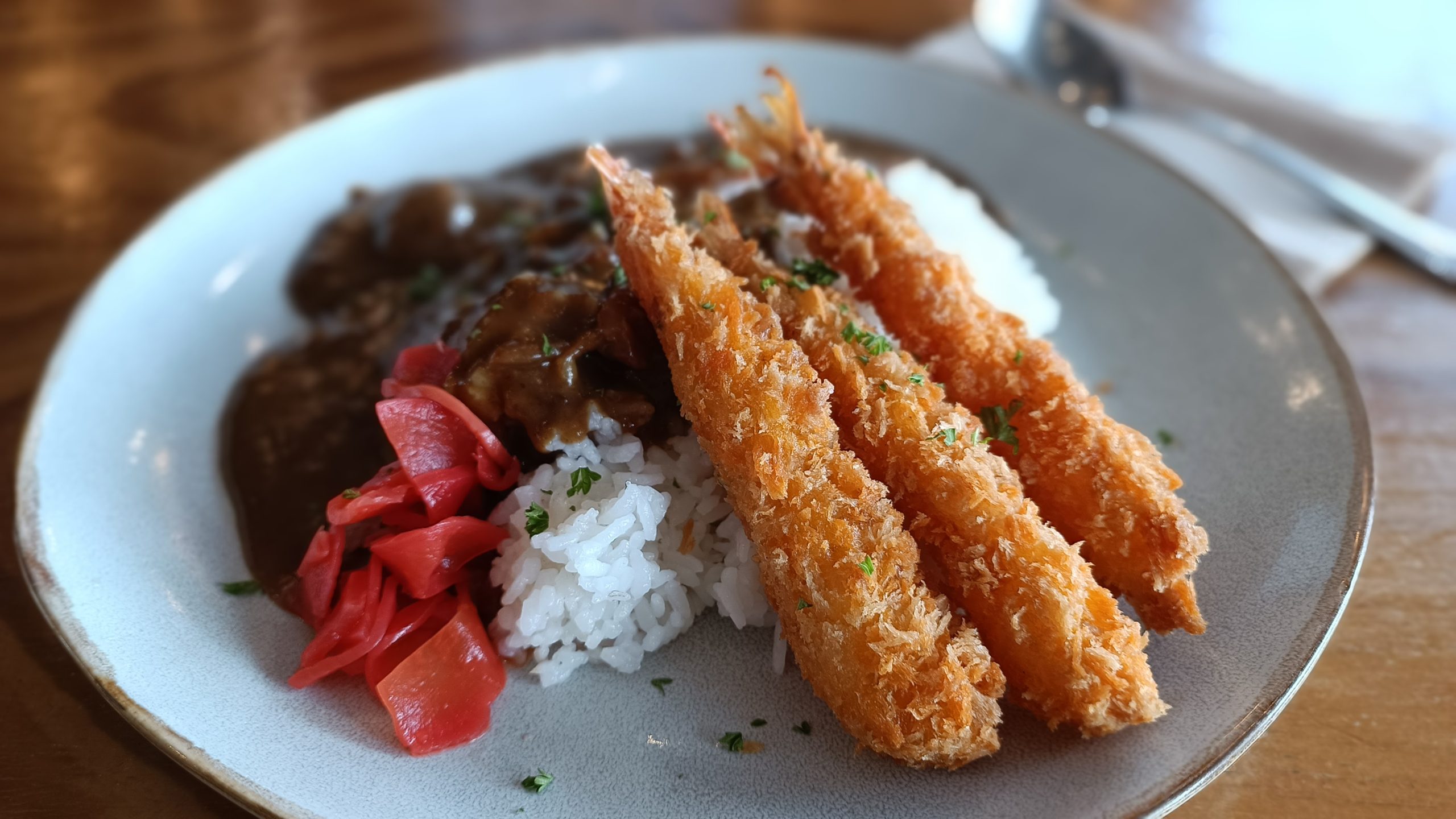 plate of prawn tempura, rice and japanese curry with pickled ginger