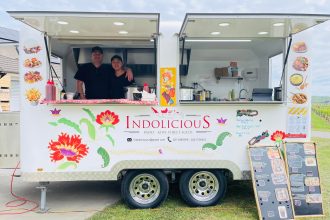 Food truck owners standing inside food truck