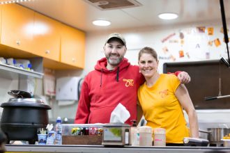 Food truck owners smiling together for the camera inside food truck